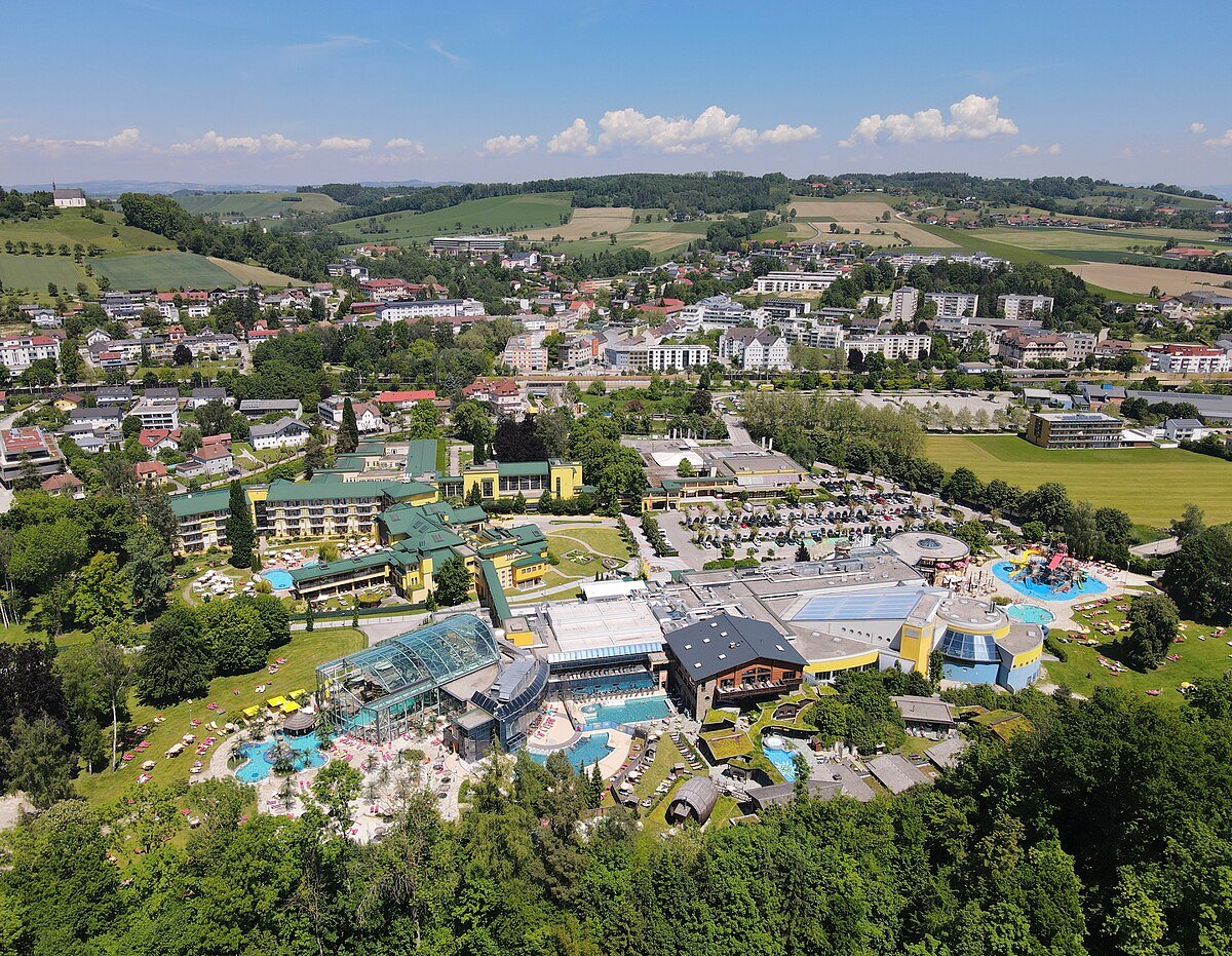 Aerial view of the Eurotherme Bad Schallerbach complex, its outdoor pools and the surrounding Upper Austrian countryside.