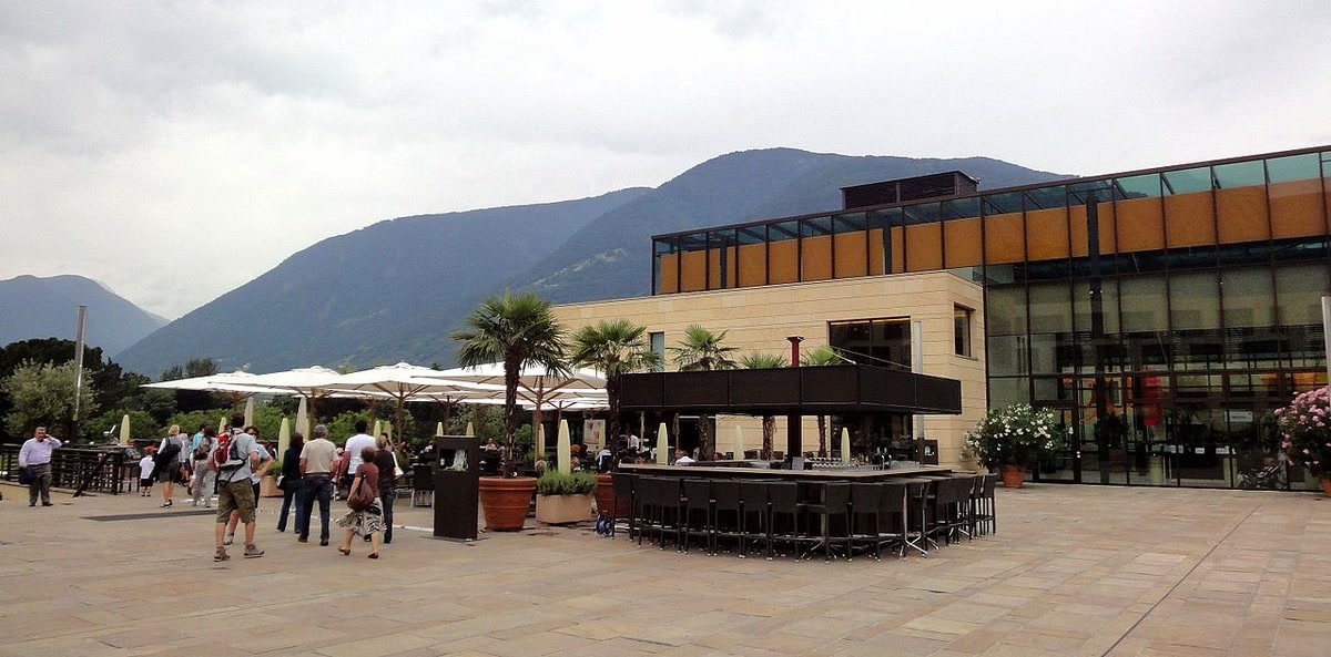 Exterior view of Terme Merano and its outdoor pool area in Merano.