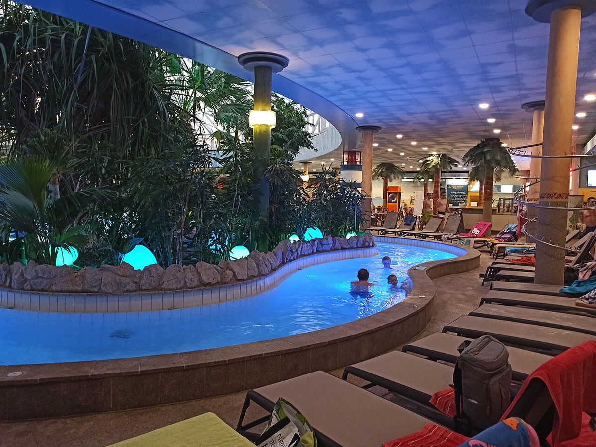 An illuminated pool inside Therme Erding.